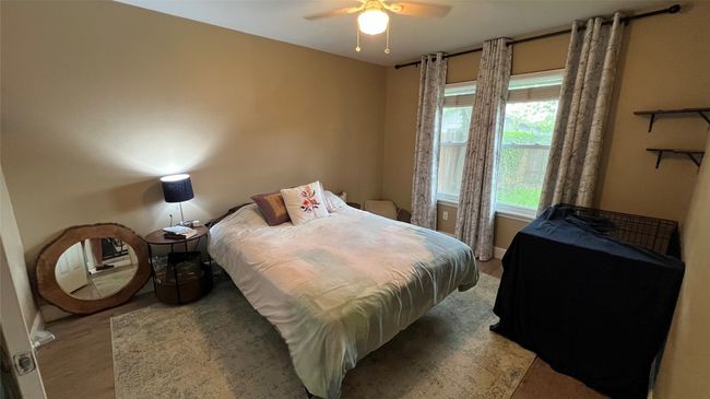 Bedroom with light wood-type flooring and a ceiling fan | Image 17