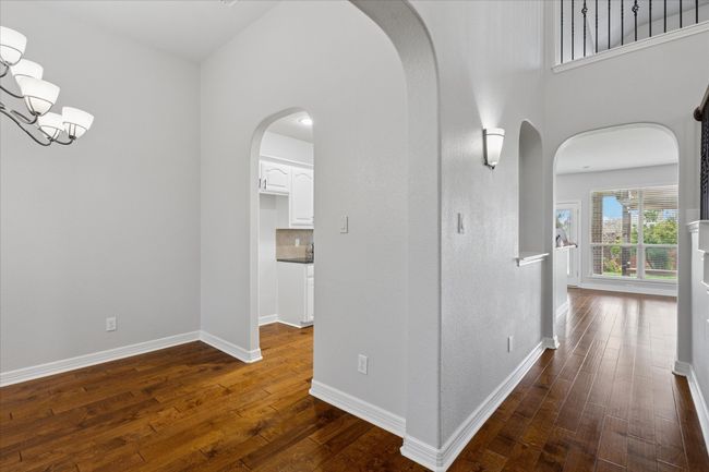 Dining area and hallway to family room. Elegant arched doorways | Image 6