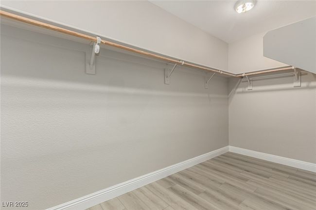 Master Walk in closet with light wood-style floors | Image 20