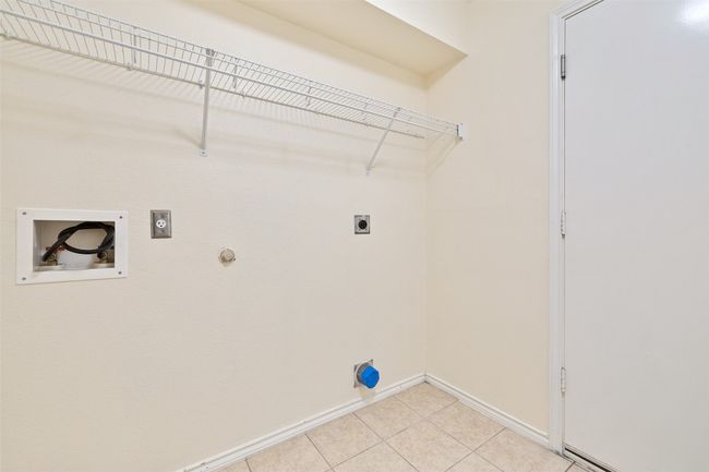 Laundry area featuring electric dryer hookup, hookup for a washing machine, baseboards, gas dryer hookup, and light tile patterned flooring | Image 20