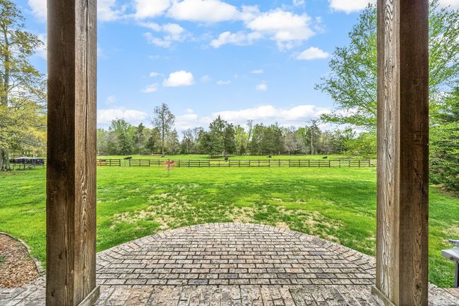 This mini-farm offers an ideal setting for those interested in small-scale farming or maintaining livestock. The property features a fenced backyard area, providing a safe and secure space for pets or children to play. | Image 12