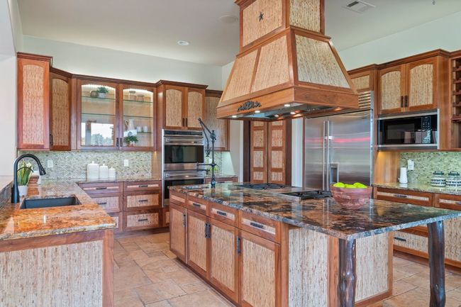 Expansive kitchen with built in SubZero refrigerator and Wolf appliances. | Image 16