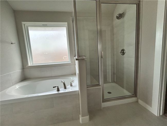 Full bathroom featuring a shower stall, a garden tub, and tile-patterned floors | Image 9