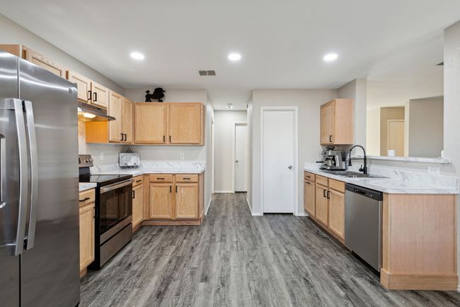 Kitchen includes pantry and other door leads to the garage | Image 7