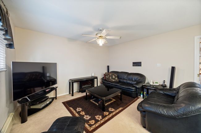Carpeted living area with ceiling fan | Image 18