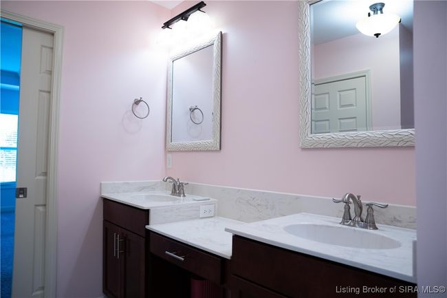 Main bathroom has two separate sink areas and a makeup vanity | Image 15