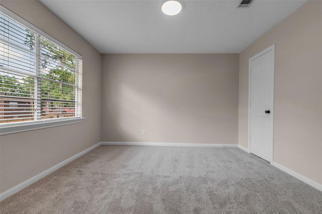 Large upstairs bedroom in the back of the home with large walk-in closet. | Image 34