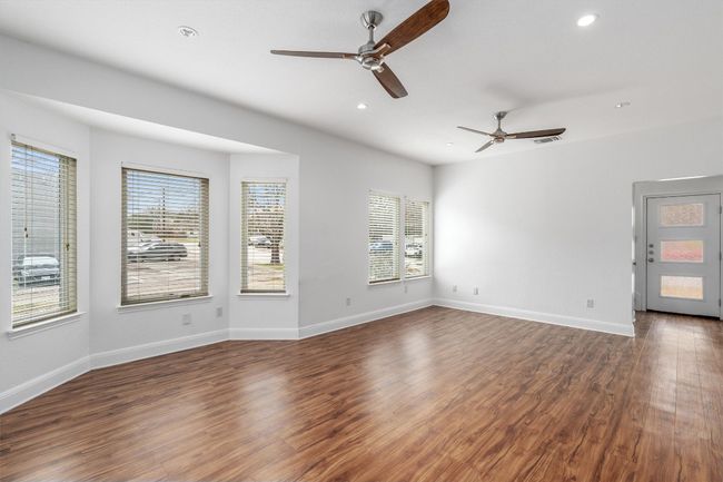 Unfurnished room with a ceiling fan, recessed lighting, and a healthy amount of sunlight | Image 5