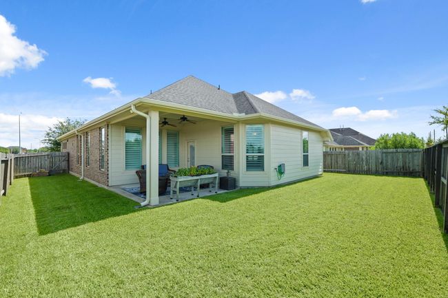 This backyard and covered patio area offers ample possibilities for outdoor entertaining, relaxation, or creating a personalized garden oasis. | Image 26