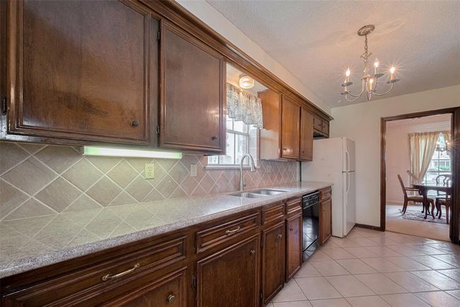This kitchen offers generous counter space, perfect for meal prep and entertaining. | Image 10