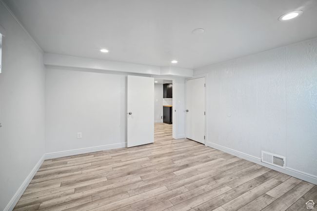 Unfurnished bedroom featuring light wood-style flooring, recessed lighting, and baseboards | Image 21