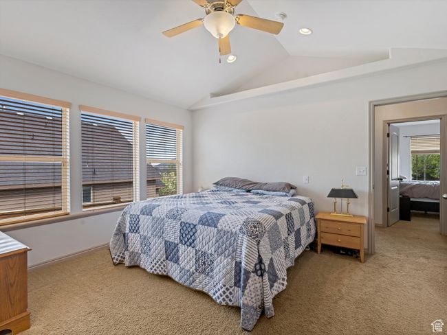 Bedroom with vaulted ceiling, light carpet, a ceiling fan, and recessed lighting | Image 17