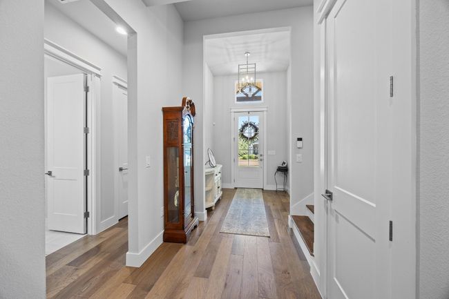 A grand entrance featuring a 12-foot ceiling and custom lighting evokes a feeling of luxury and spaciousness. | Image 5