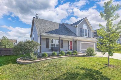 View of front of home featuring a garage and a front lawn | Image 2