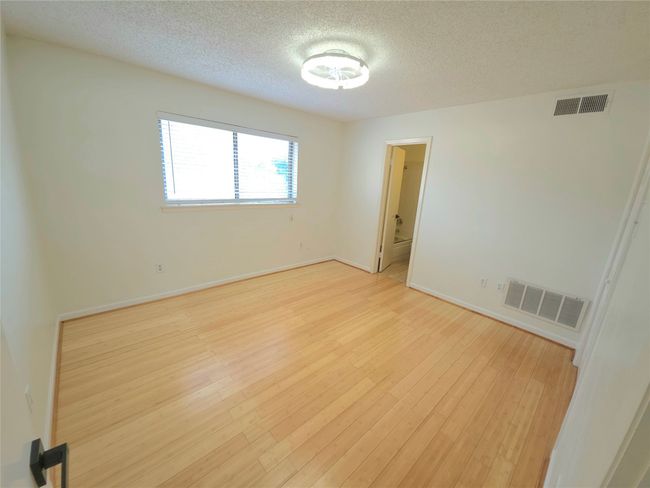 Empty room featuring a textured ceiling and light wood-type flooring | Image 17