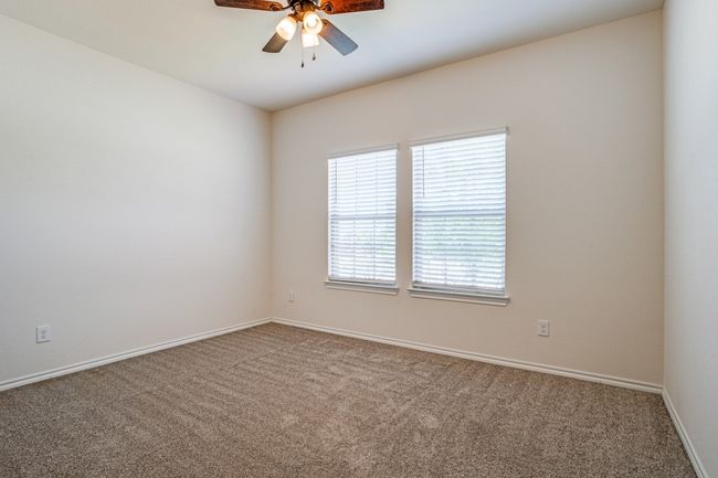 Unfurnished room with carpet flooring and a ceiling fan | Image 5