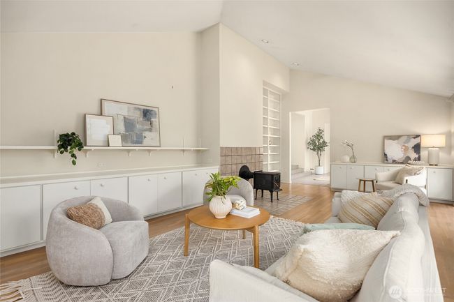 The library features a stove fireplace, hardwoods, vaulted ceilings, and many built-ins. | Image 6