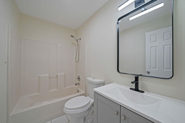 Full bathroom with toilet, vanity, and bathtub / shower combination | Image 17