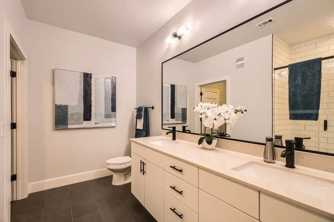 Master bathroom featuring tile patterned flooring, double vanity, and tiled shower | Image 19