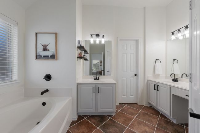 Full bathroom featuring tile patterned floors, a bath, and two vanities | Image 21