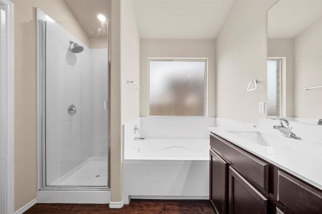 Full bathroom with a shower stall, a garden tub, vanity, and wood finished floors | Image 20