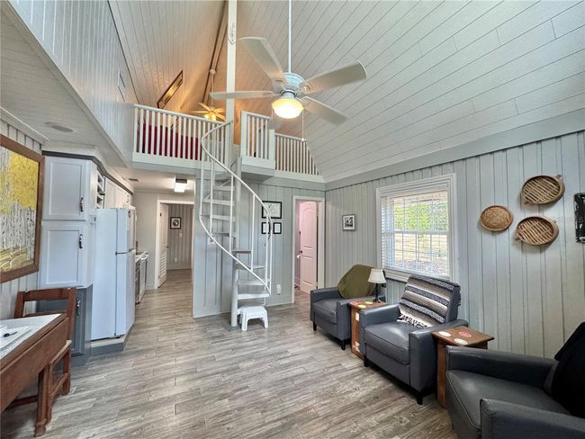 Living room with spiral stairs to loft bedroom | Image 7