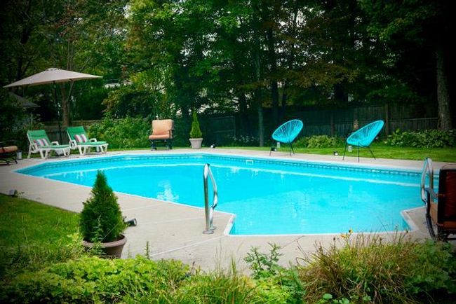 View of swimming pool with a patio | Image 29