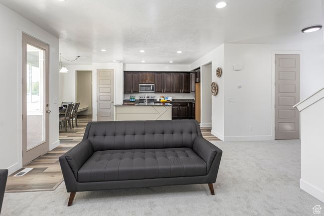 Living room featuring baseboards, recessed lighting, visible vents, and light colored carpet | Image 12