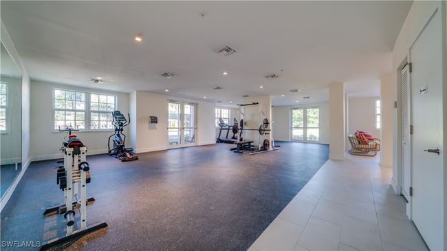 Exercise room with french doors and light tile patterned floors | Image 18