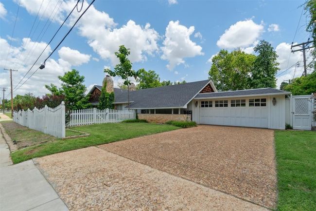 View of front of home featuring an attached garage, driveway, and a shingled roof | Image 42