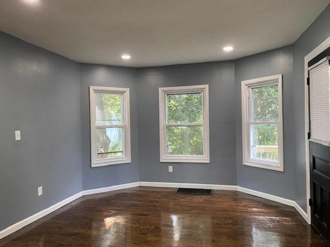 Empty room with dark wood-style floors and recessed lighting | Image 10