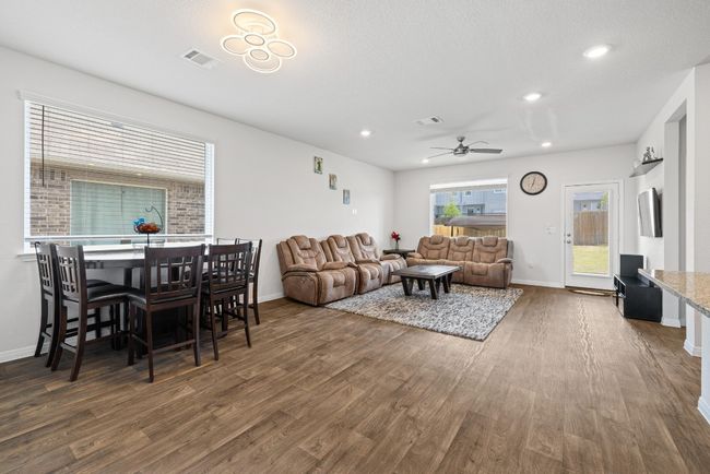 Living area featuring wood finished floors, ceiling fan, baseboards, and recessed lighting | Image 5