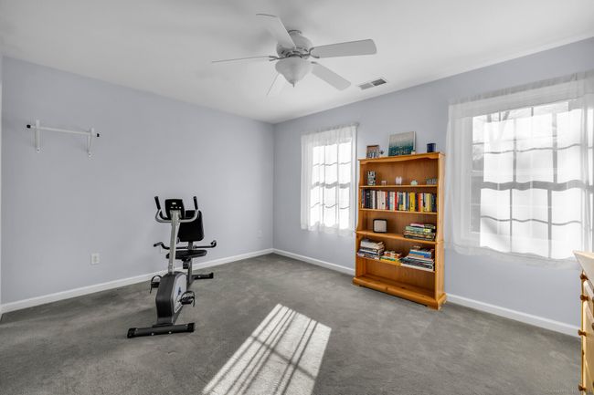Bedroom #3 with wall-to-wall carpet and ceiling fan. | Image 22