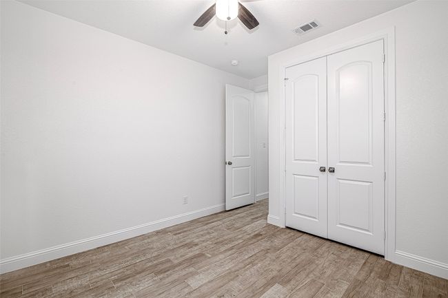 Unfurnished bedroom with light wood finished floors, a closet, baseboards, and a ceiling fan | Image 18