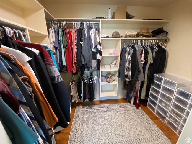 Spacious closet with wood finished floors | Image 15