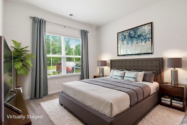 Bedroom with light carpet and baseboards | Image 6