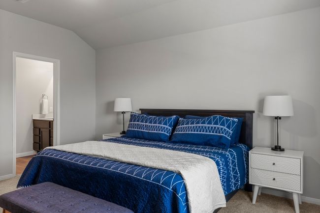 Carpeted bedroom with baseboards and lofted ceiling | Image 14