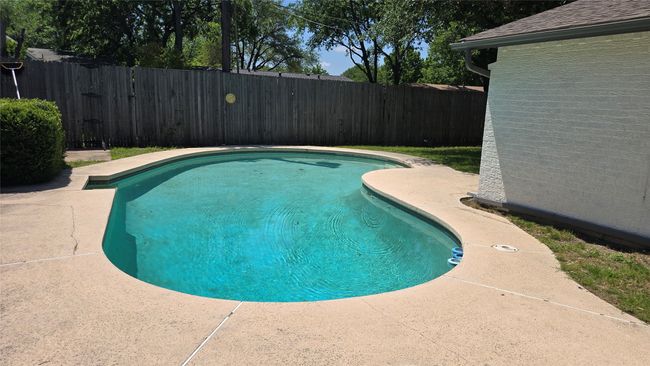 View of pool from just outside the french doors. Access to alley is on the otherside of pool long the fence. | Image 4