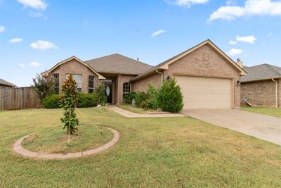 Single story home with a garage and a front yard | Image 1