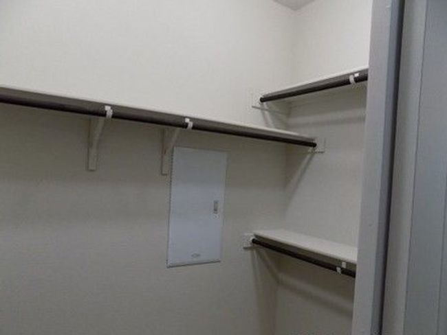 Walk in closet featuring electric panel | Image 9