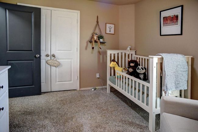 Bedroom featuring a nursery area, carpet floors, and baseboards | Image 23