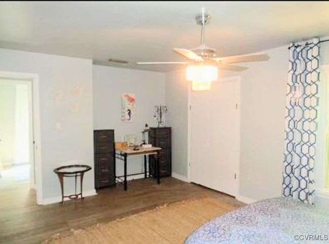 Bedroom with baseboards and wood finished floors | Image 17