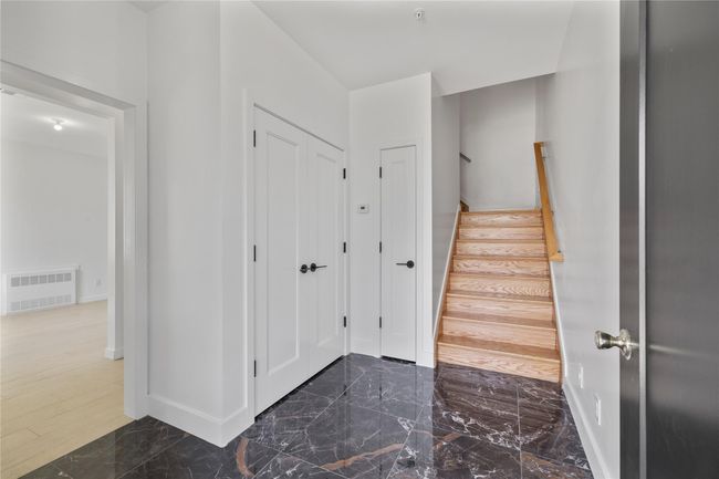 Stairs featuring visible vents, marble finish floor, and baseboards | Image 4