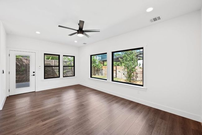 Living room with view of back yard and covered patio | Image 10