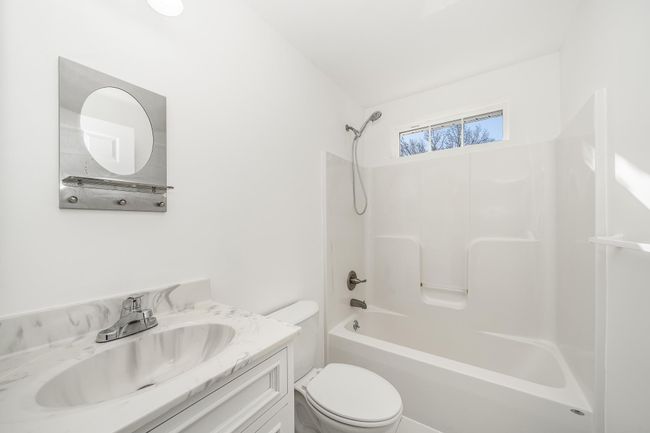 Bathroom with toilet, vanity, and bathtub / shower combination | Image 18