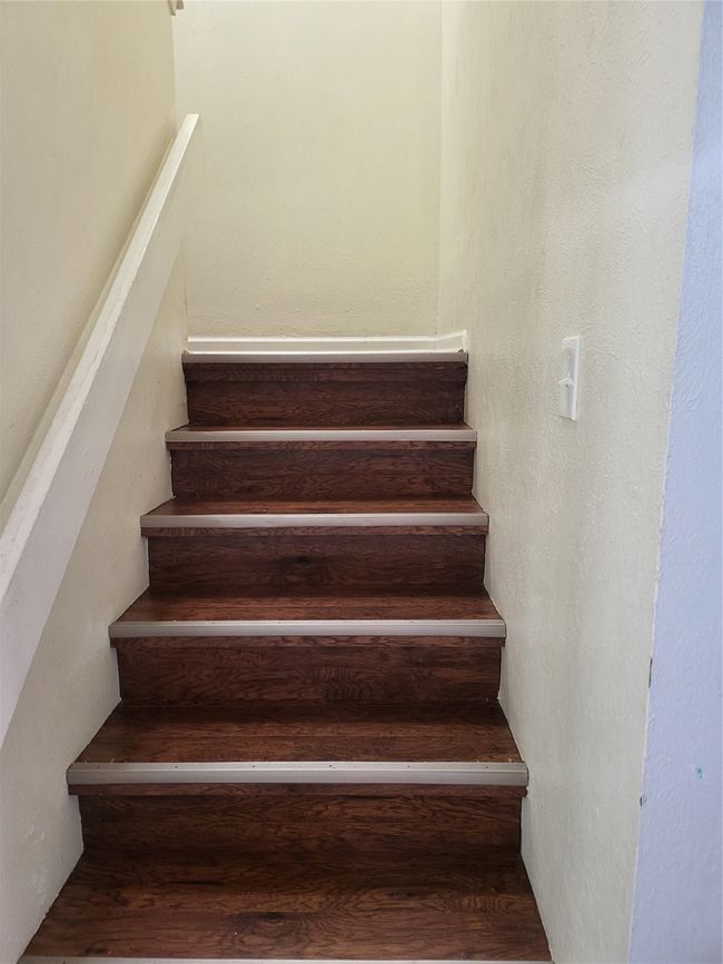 Stairs featuring wood finished floors | Image 8