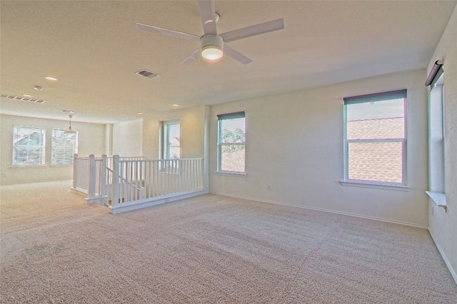 Empty room with carpet floors, plenty of natural light, ceiling fan, and recessed lighting | Image 22