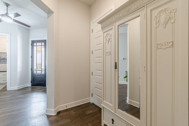 Foyer featuring dark wood-style flooring, ceiling fan, and baseboards | Image 9