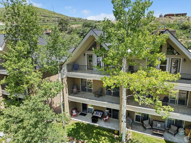 Rear view of house with outdoor lounge area, a patio, and a balcony | Image 32