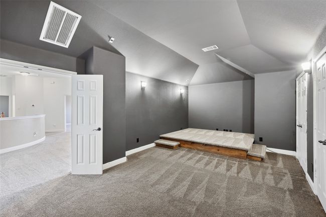 Additional living space with carpet, lofted ceiling, and a textured ceiling | Image 22